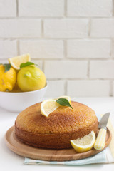 Lemon lavender cake and lemons on a light background. Rustic style.