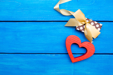 wooden heart with a bow on a blue background, Valentine's Day