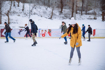 woman learn to ski at city ice rink