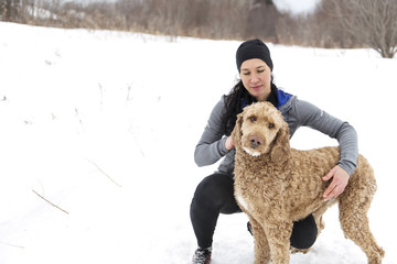 Woman with goldendoodle winter season