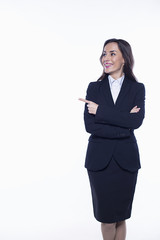 Confident beautiful smiling young business woman in suit on white background isolated pointing finger at empty field.