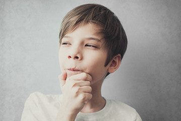 Portrait of thoughtful and cunning boy