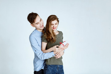 Valentine or birthday gift. happy couple with present isolated on a white background. Happy man giving a gift to his girlfriend 