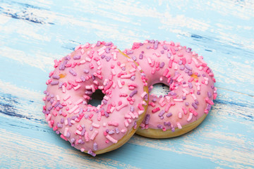 Traditional donuts on blue wooden background.  Tasty doughnuts with icing, copy space