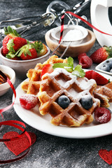 Valentine concept. Traditional belgian waffles with fresh fruit and powder sugar on wooden board