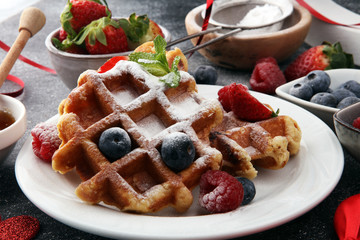 Valentine concept. Traditional belgian waffles with fresh fruit and powder sugar on wooden board