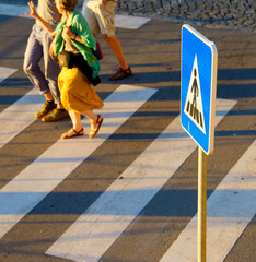 Naklejka na ściany i meble Crosswalk sign. People on background