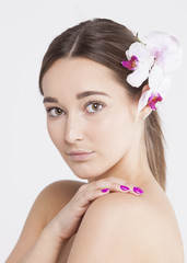 Portrait of a beautiful woman with flowers in her hair on an isolated white background 