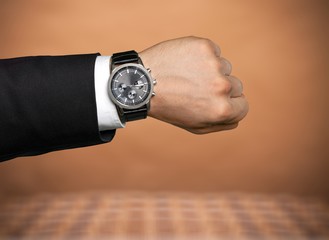 Businessman pointing at hand watch