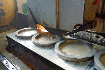 grinding on a machine with a cooling emulsion. metalworking machining industry. finishing or grinding metal surface on grinder machine at factory