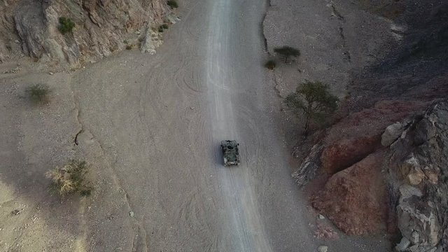 Armed military patrol clearing a route - Aerial footage