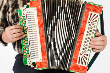 Musician hand playing accordions closeup. isolated on white background.