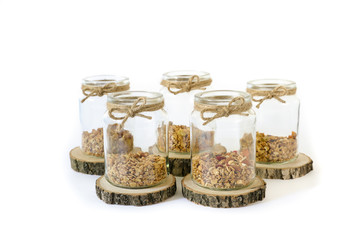 Granola in jars isolated on white background.