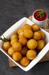 Potato fried croquettes with ketchup.
