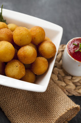 Potato fried croquettes with ketchup.