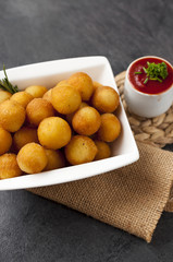 Potato fried croquettes with ketchup.