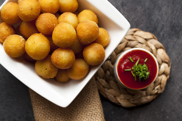 Potato fried croquettes with ketchup.