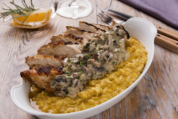 rice paella with curry fried chicken breast and mushrooms in creamy sauce