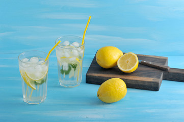 homemade lemonade - lemon, mint, ice and water in glasses