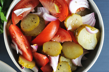 salad appetizer with tomatoes, pickles and onions