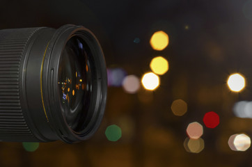 Fototapeta na wymiar glass lens on the background of the night bokeh