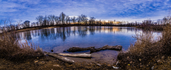 A small lake on a cloudy winter day at sunset