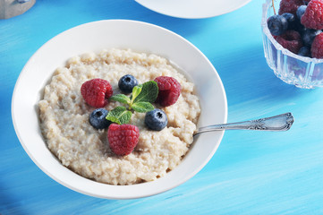 Breakfast oatmeal porridge on a blue background