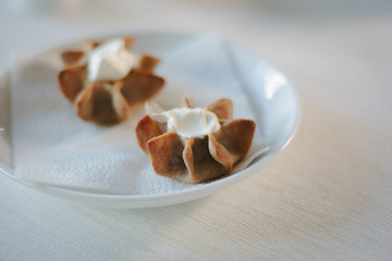 Nice appetizer snacks - tartlets on a white ceramic plate.