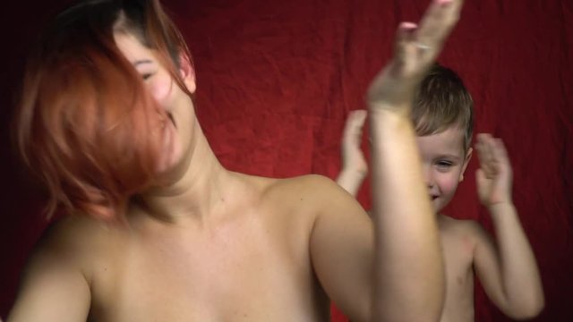 Mom and her son slap their heads and laugh, slow motion