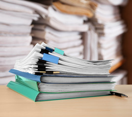 Stack of documents on table in archive