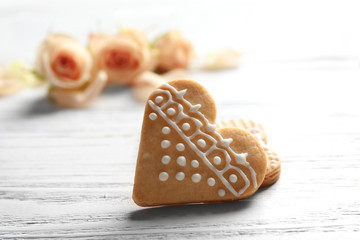 Heart-shaped cookies on white wooden background