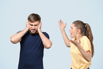 Couple arguing on light background. Problems in relationship