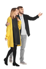 Young couple in casual clothes walking on white background © Africa Studio
