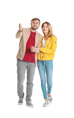 Obraz premium Young couple in casual clothes walking on white background