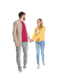 Young couple in casual clothes walking on white background