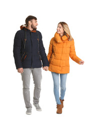 Fototapeta premium Young couple in casual clothes walking on white background
