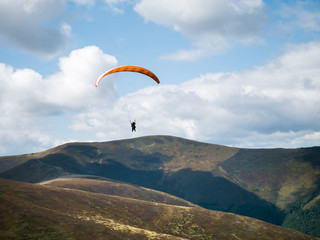 Stunning mountain landscape with Paraglider. The mountain range in the Carpathians. View from the mountain Gemba, (Pylypets, Zakarpatska oblast, Ukraine)