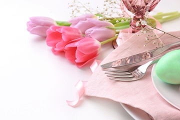 Beautiful festive Easter table setting with flowers and painted egg on white background, closeup