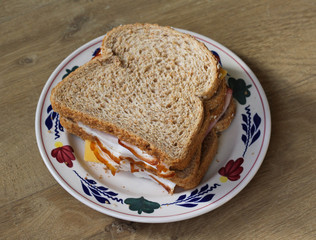 Two ham and cheese sandwiches on plate