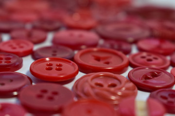red sewing buttons on white