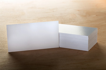 Close Up of blank horizontal business cards at wooden background