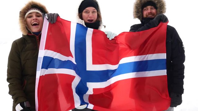 Norwegian fans with the national flag scream and jump