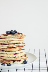 blueberry pancakes on white background