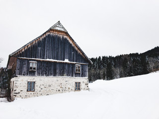 snowed in country house in winter in the mountains