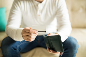 Man checking his credit card from wallet