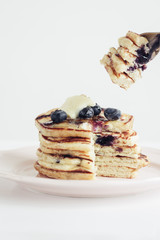 blueberry pancakes on white background