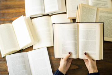 Fototapeta premium Woman reading several books