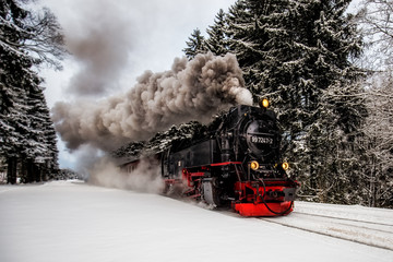 Steam train on the way to Brocken through winter landscape