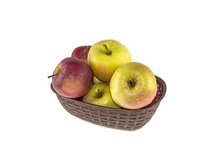 wet apples in a basket on a white background