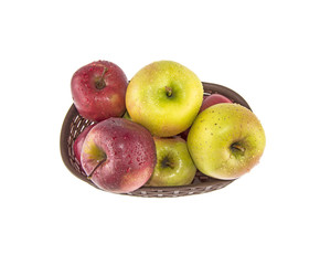 wet apples in a basket on a white background